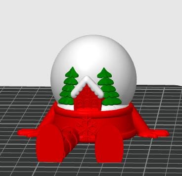 May include: A red snow globe figurine featuring a white sphere top with two green pine trees and a red house with a white snow-covered roof. The base is red with a snowflake emblem and two extended red legs and arms in a seated position.