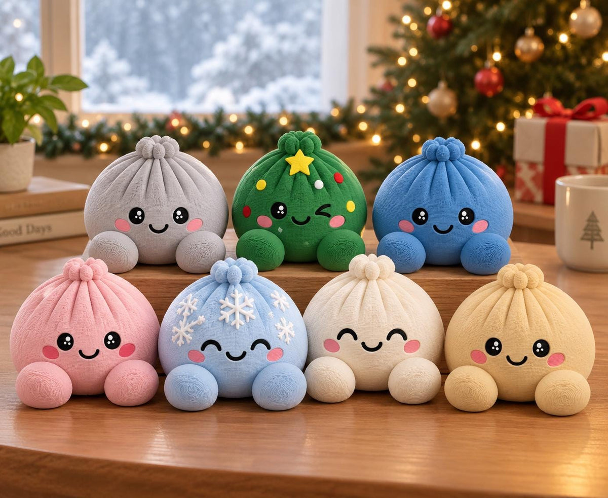 May include: A collection of seven plush dumpling toys with smiling faces and rosy cheeks. The colors include gray, green with a yellow star, blue, pink, light blue with white snowflakes, white, and beige. Each has a small knot on top.