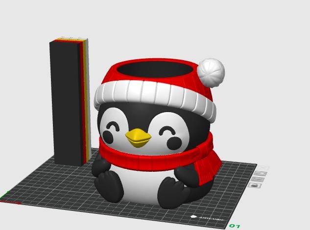 May include: A 3D-rendered penguin planter featuring a black and white body, a yellow beak, and a red winter hat with a white pom-pom and brim. The penguin wears a matching red scarf and has a hollow top opening for plants, presented on a grid base.