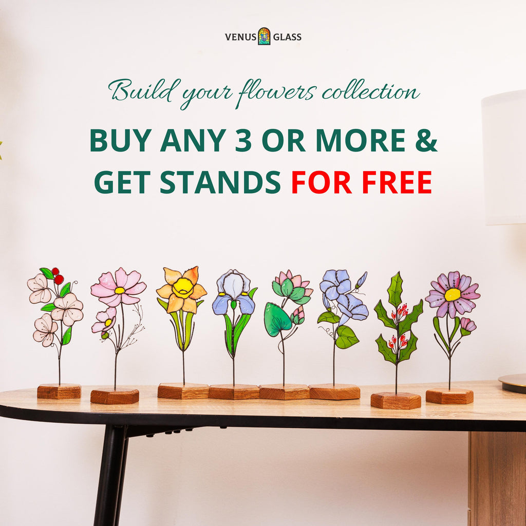 May include: Eight individual stained glass flower ornaments, each mounted on a small hexagonal wooden base. The flowers include pink, yellow, purple, and green designs with wire stems. Text reads: VENUS GLASS, Build your flowers collection, BUY ANY 3 OR MORE & GET STANDS FOR FREE.