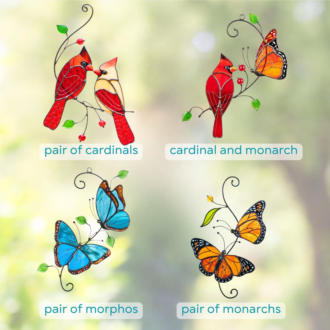 Stained glass suncatchers showing different designs: pair of cardinals, cardinal with monarch butterfly, pair of morpho butterflies, and pair of monarch butterflies.