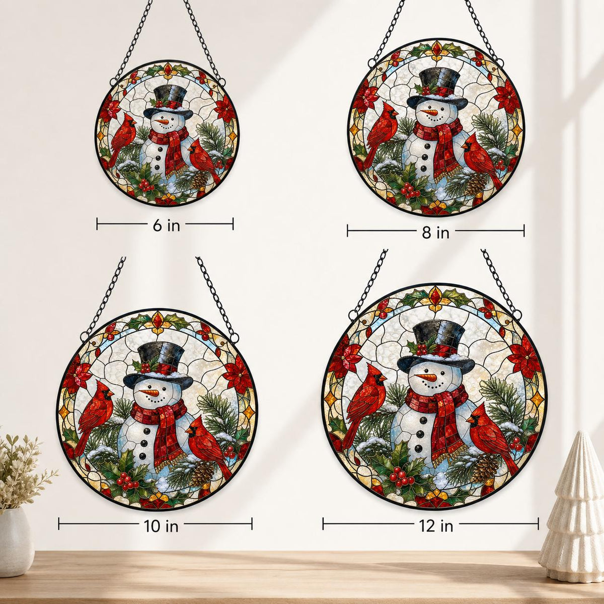 May include: Four circular stained glass suncatchers featuring a snowman wearing a top hat and red scarf, surrounded by red cardinals, holly, and pine branches. The diameters are labeled as 6 inches, 8 inches, 10 inches, and 12 inches respectively.