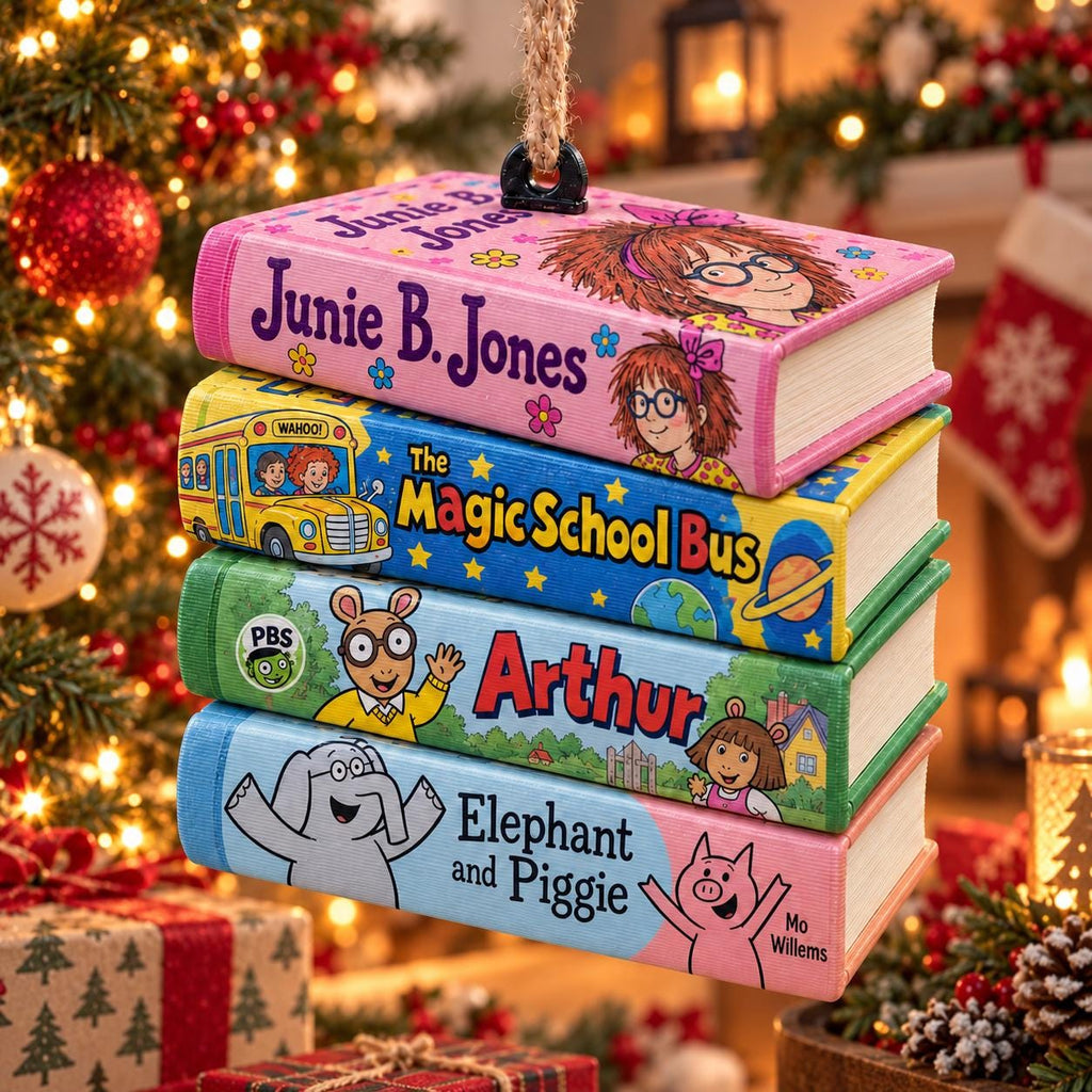 May include: A stack of four rectangular book-shaped ornaments hanging from a jute rope. The top book is pink with Junie B. Jones text, the second is blue with The Magic School Bus, the third is green with Arthur, and the bottom is light blue with Elephant and Piggie.