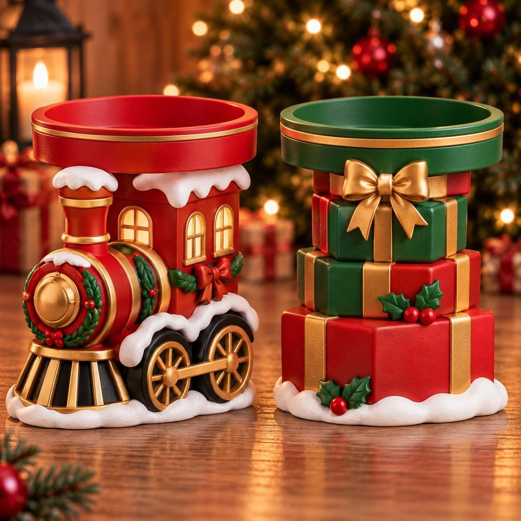 May include: Two ceramic wax warmers featuring holiday designs. One is a red train engine with gold wheels and white snow accents. The other is a stack of three red and green gift boxes tied with a gold ribbon and topped with a gold bow.