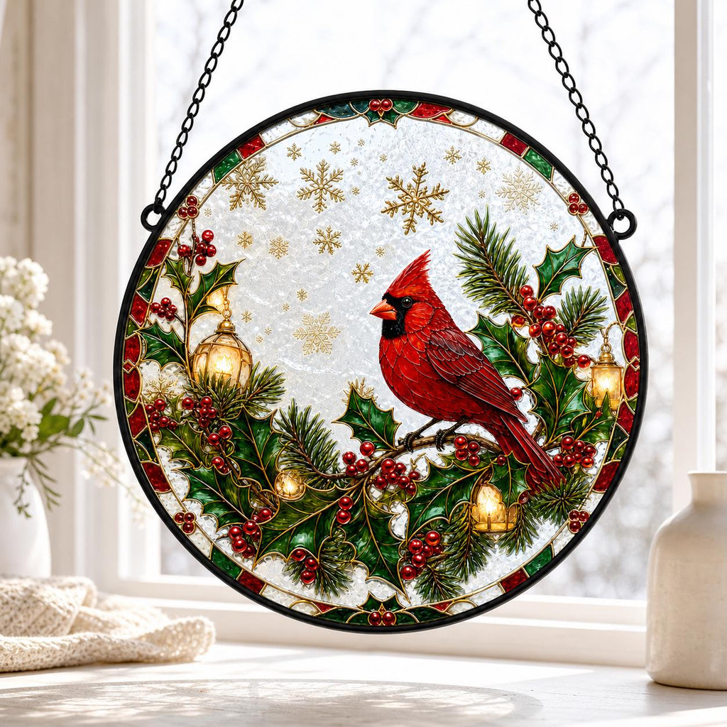 May include: A circular stained glass suncatcher featuring a vibrant red cardinal perched on a holly branch with green leaves and red berries. The design includes gold lanterns, golden snowflakes, and a black metal frame with a hanging chain.