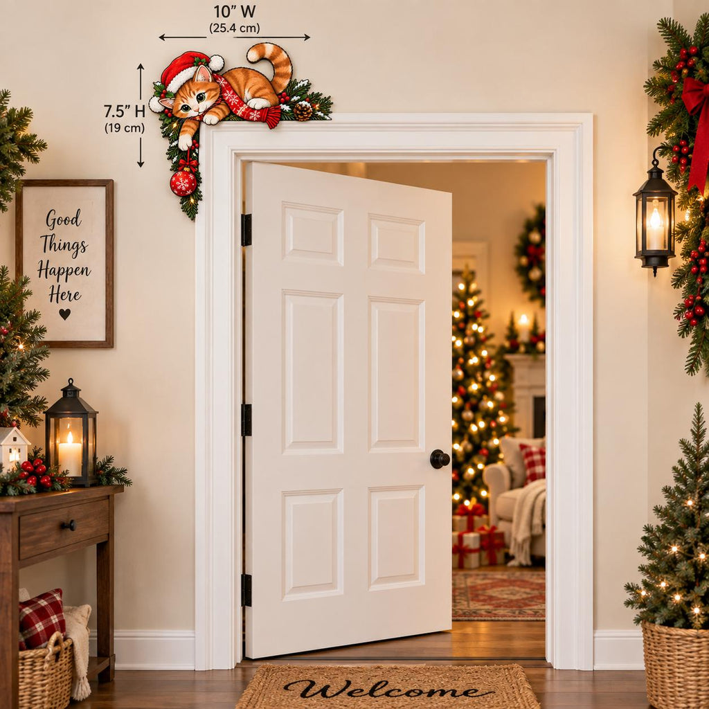 May include: A decorative wooden door corner sign featuring an orange tabby cat wearing a red Santa hat and scarf, nestled in green pine branches with a red ornament. The sign measures 10 inches wide by 7.5 inches high, designed for placement.