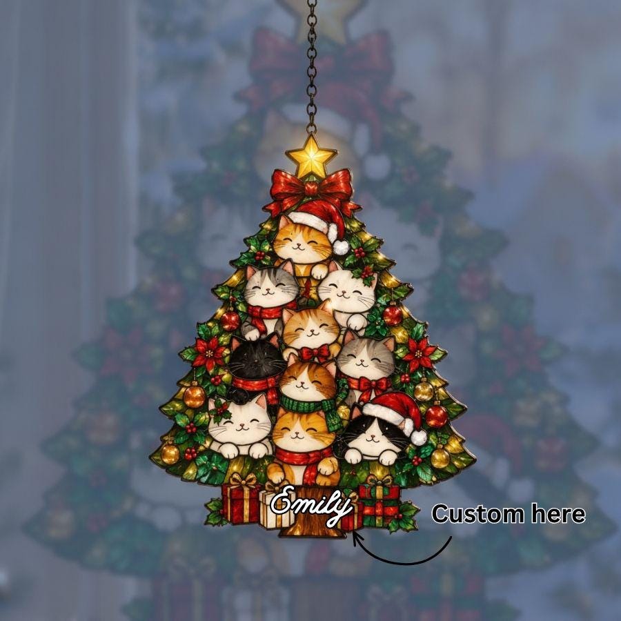 May include: A triangular Christmas tree ornament featuring multiple illustrated cats wearing scarves and Santa hats, decorated with red and gold ornaments, topped with a yellow star, and hanging from a chain with the name Emily printed at the base.