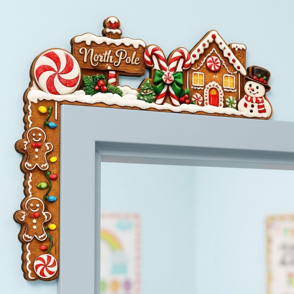 May include: A Christmas-themed door corner decoration featuring a brown gingerbread house, a snowman, a North Pole sign, candy canes, and peppermint candies. The vertical section includes two gingerbread people and colorful string lights.