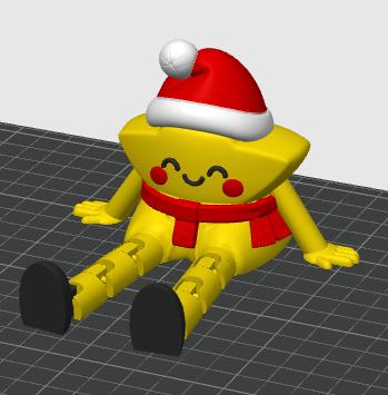 May include: A yellow star-shaped figure with a smiling face, red cheeks, and articulated limbs. The figure wears a red and white Santa hat and a red scarf. It has black feet and is positioned in a seated pose on a gray grid surface.