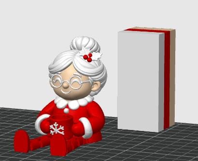 May include: A 3D rendered figurine of a character with white hair in a bun, wearing round glasses and a red outfit with white trim. The character holds a red mug featuring a white snowflake design. Beside the figure is a tall, rectangular block.