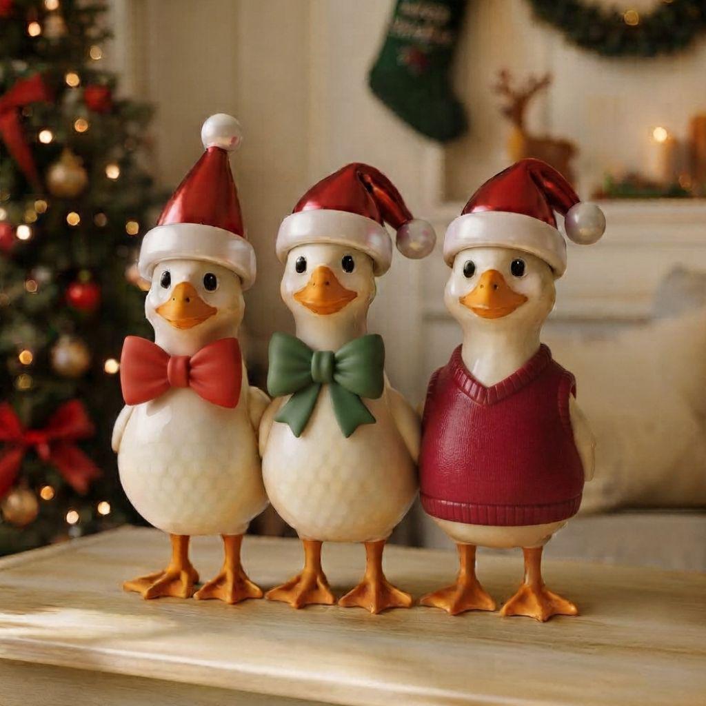 May include: Three white duck figurines standing side by side. The left duck wears a red Santa hat and a red bow tie. The middle duck wears a red Santa hat and a green bow tie. The right duck wears a red Santa hat and a red knitted sweater vest.