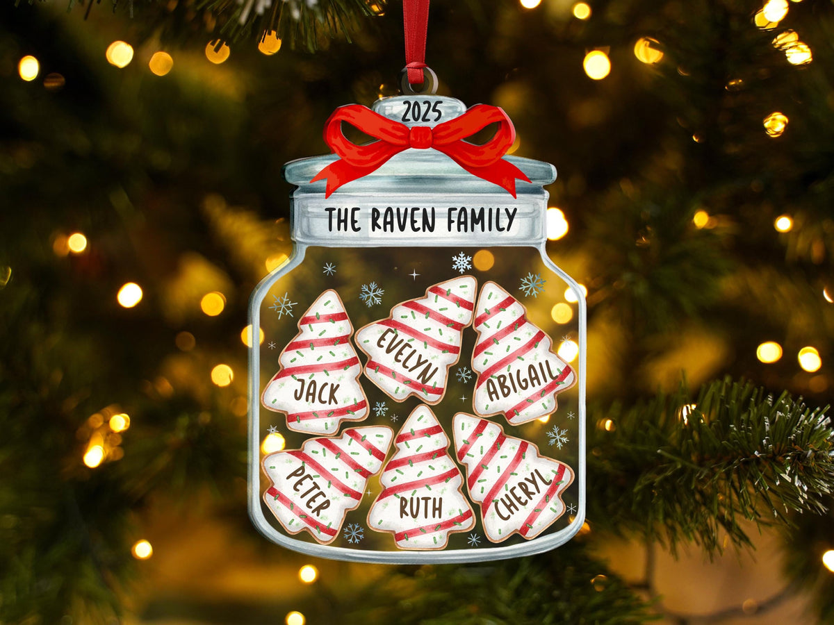 May include: A clear glass jar ornament featuring a red ribbon bow at the top and the text 2025 and THE RAVEN FAMILY. Inside the jar are six white and red striped Christmas tree cookies, each personalized with the names Jack, Evelyn, Abigail, Peter, Ruth, and Cheryl.