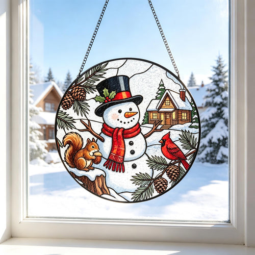 May include: A circular stained glass suncatcher featuring a central snowman wearing a black top hat and red scarf, flanked by a brown squirrel on a tree stump and a red cardinal on a pine branch, with a cabin in the background and a metal chain.