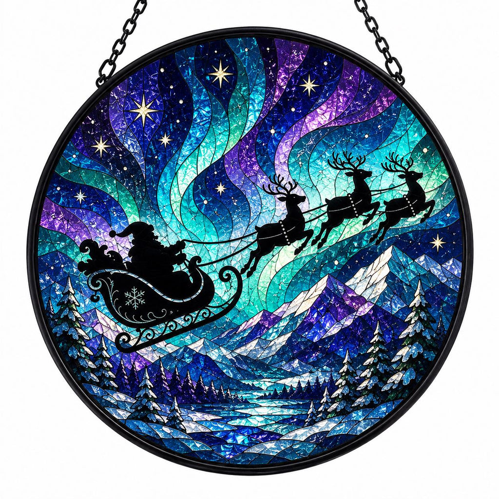 Northern lights stained glass suncatcher with Santa sleigh and reindeer soaring across vivid blue, turquoise, and purple aurora above snowy mountains.
