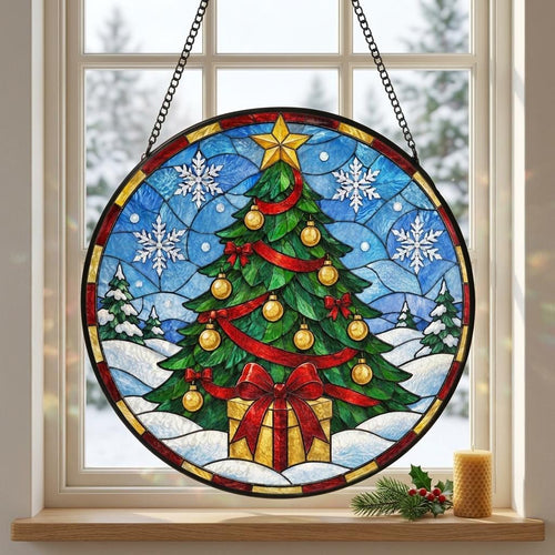 May include: A circular stained glass suncatcher featuring a green Christmas tree decorated with gold ornaments, red ribbons, and a yellow star topper. The scene includes white snowflakes, a gift box with a red bow, and a snowy landscape background.