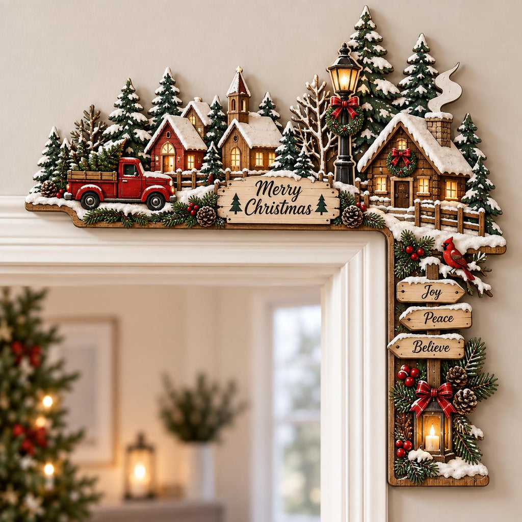 May include: A wooden Christmas door corner decoration featuring a snowy village scene with a red truck, houses, pine trees, and a street lamp. A sign reads Merry Christmas, while hanging signs below display the words Joy, Peace, and Believe.