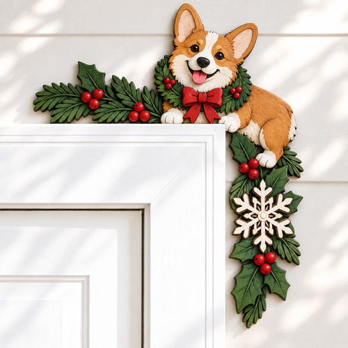 May include: A decorative door corner accent featuring a brown and white Corgi dog wearing a green holly wreath with a red bow. The design includes green holly leaves, red berries, and a white snowflake ornament extending down the side of the frame.