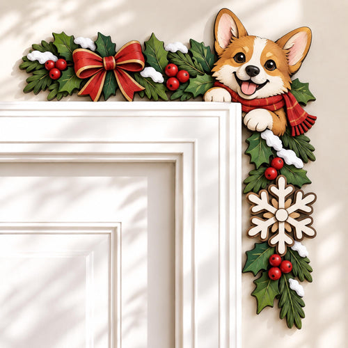 May include: A decorative door corner topper featuring a smiling Corgi dog wearing a red scarf, surrounded by green holly leaves, red berries, white snow accents, a large red bow, and a wooden snowflake, designed to frame the top corner of a door.