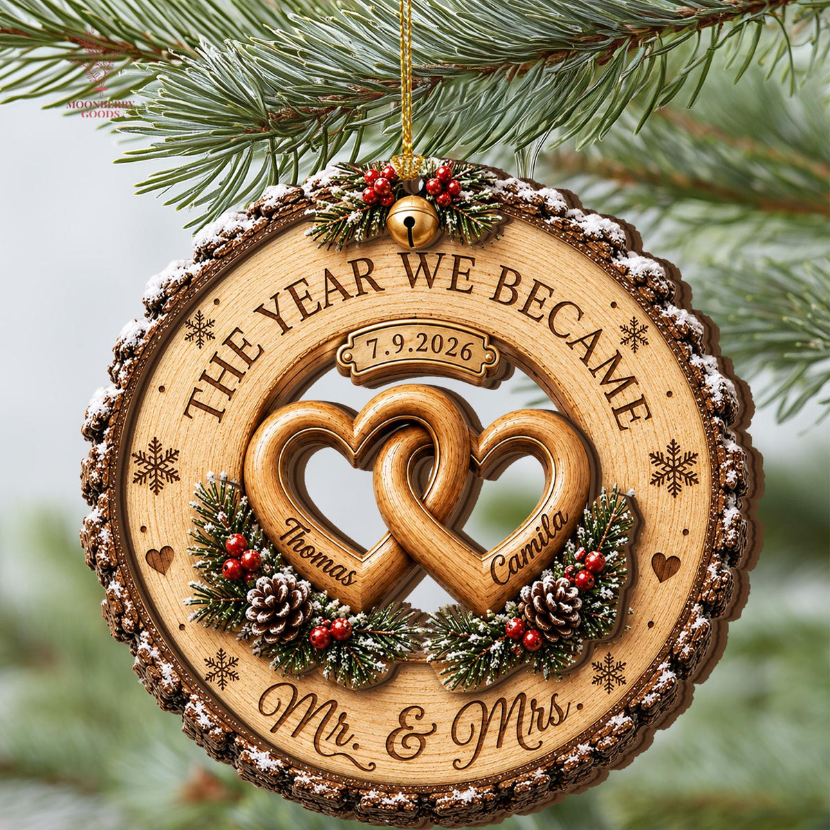 May include: A round wooden Christmas ornament featuring a bark-textured edge with faux snow. It displays two interlocking hearts engraved with the names Thomas and Camila, the text THE YEAR WE BECAME, Mr. & Mrs., and the date 7.9.2026.