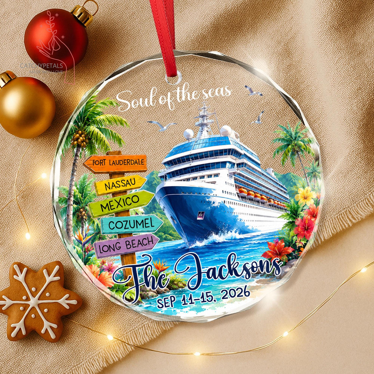 May include: A round glass ornament with a red ribbon featuring a cruise ship on blue water, palm trees, and tropical flowers. A wooden signpost lists Fort Lauderdale, Nassau, Mexico, Cozumel, and Long Beach. Text reads Soul of the seas, The Jacksons, and SEP 11-15, 2026.