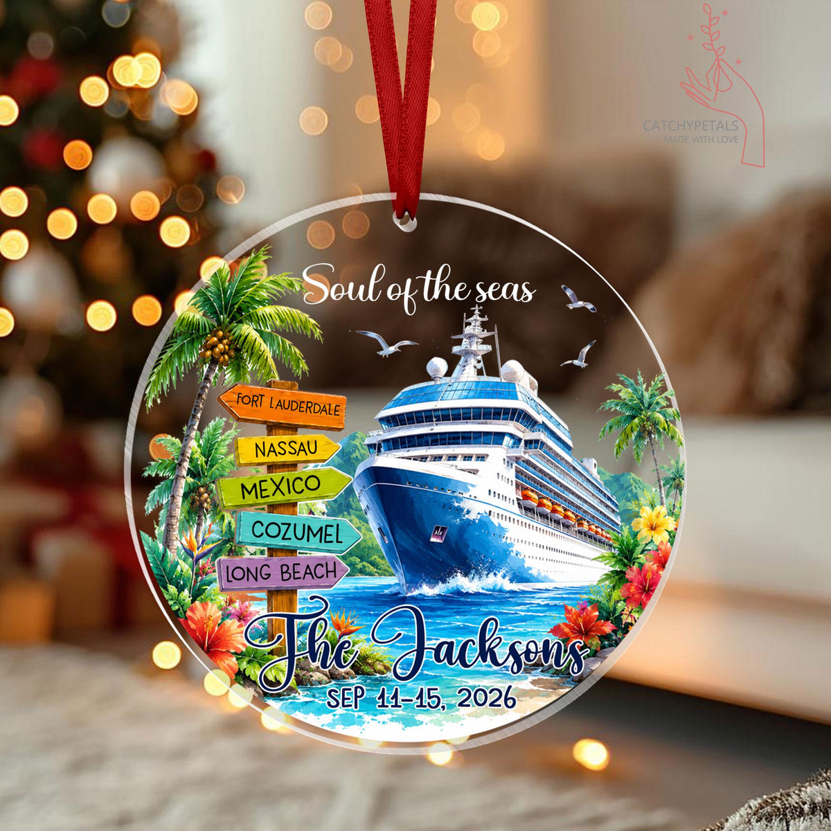 May include: A round clear ornament with a red ribbon featuring a cruise ship, palm trees, and colorful directional signs reading Fort Lauderdale, Nassau, Mexico, Cozumel, and Long Beach. Text includes Soul of the seas, The Jacksons, and SEP 11-15, 2026.