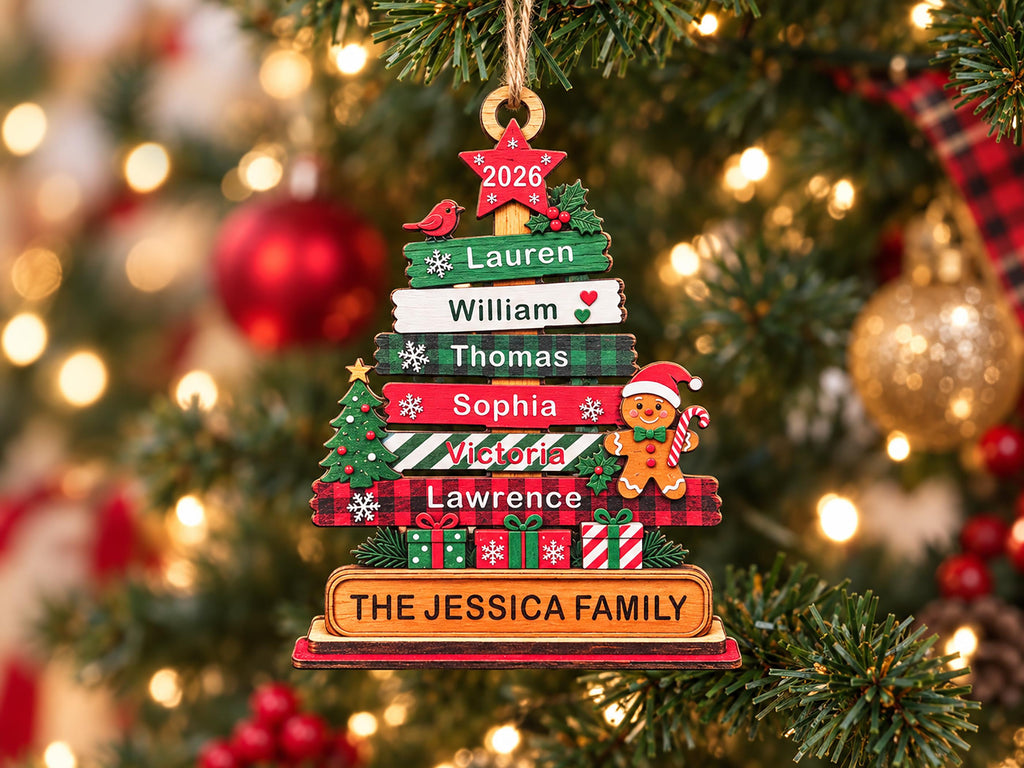 May include: A wooden Christmas tree ornament featuring horizontal slats with the names Lauren, William, Thomas, Sophia, Victoria, and Lawrence. It includes a red star with 2026, a gingerbread man, and a base labeled The Jessica Family.