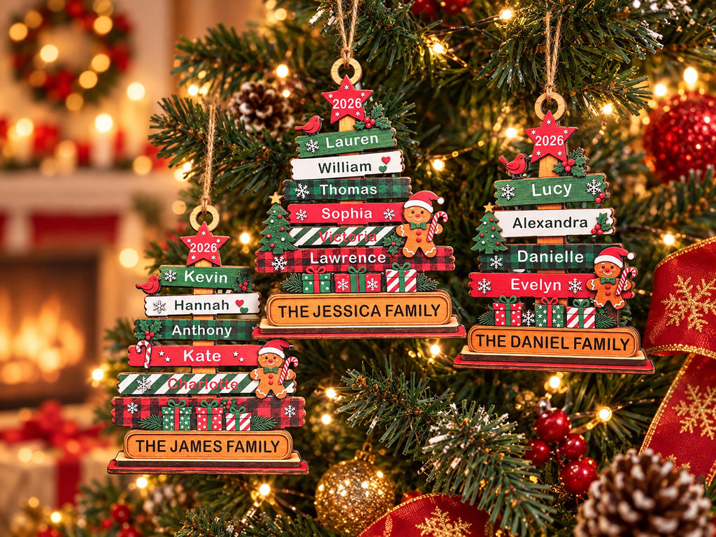 May include: Three wooden Christmas tree ornaments featuring stacked horizontal planks with personalized names, the year 2026, and family surnames. Each ornament is decorated with small gingerbread figures, gift boxes, and red birds, hanging from twine loops.