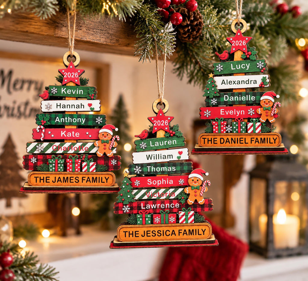 May include: Three wooden Christmas tree ornaments featuring stacked horizontal planks in red, green, and white. Each ornament displays the year 2026 on a top star, personalized names, gingerbread figures, gift boxes, and a family name at the base.