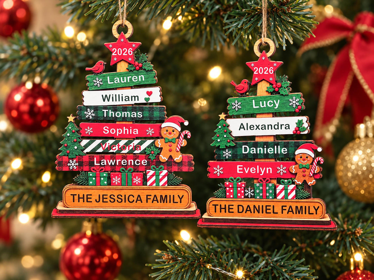 May include: Two wooden Christmas tree ornaments featuring stacked horizontal planks in red, green, and white. Each ornament displays names, a gingerbread person, a red star with 2026, and a base labeled THE JESSICA FAMILY or THE DANIEL FAMILY.