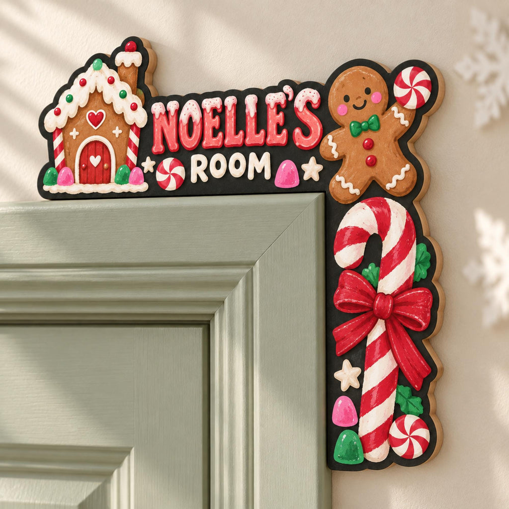 May include: A black L-shaped door corner sign featuring a gingerbread house, a gingerbread person holding a peppermint candy, and a large candy cane with a red bow. The text reads NOELLE'S ROOM in red and white letters with small candy accents.