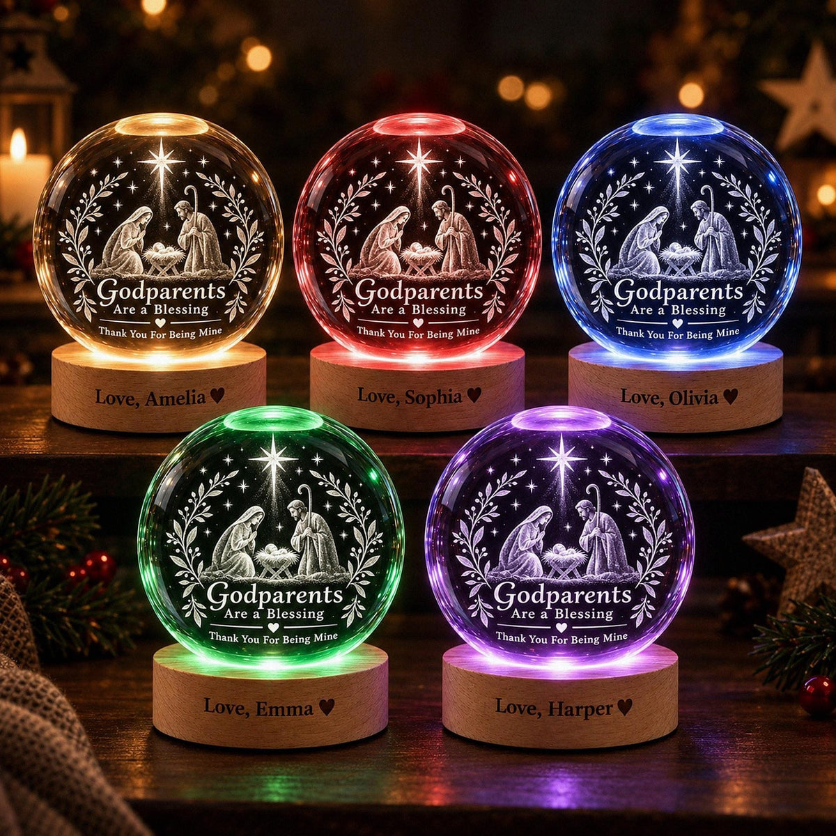 May include: Five spherical glass ornaments on wooden bases, each featuring an engraved nativity scene and the text "Godparents Are a Blessing Thank You For Being Mine." The bases are personalized with "Love, Amelia," "Love, Sophia," "Love, Olivia," "Love, Emma," and "Love, Harper."