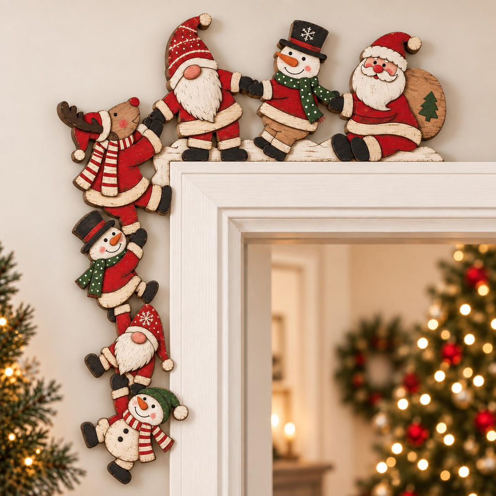 May include: A wooden door frame decoration featuring a chain of Christmas characters including a reindeer, gnomes, snowmen, and Santa Claus. The figures are painted in red, white, green, and brown, arranged to wrap around the corner of a door frame.
