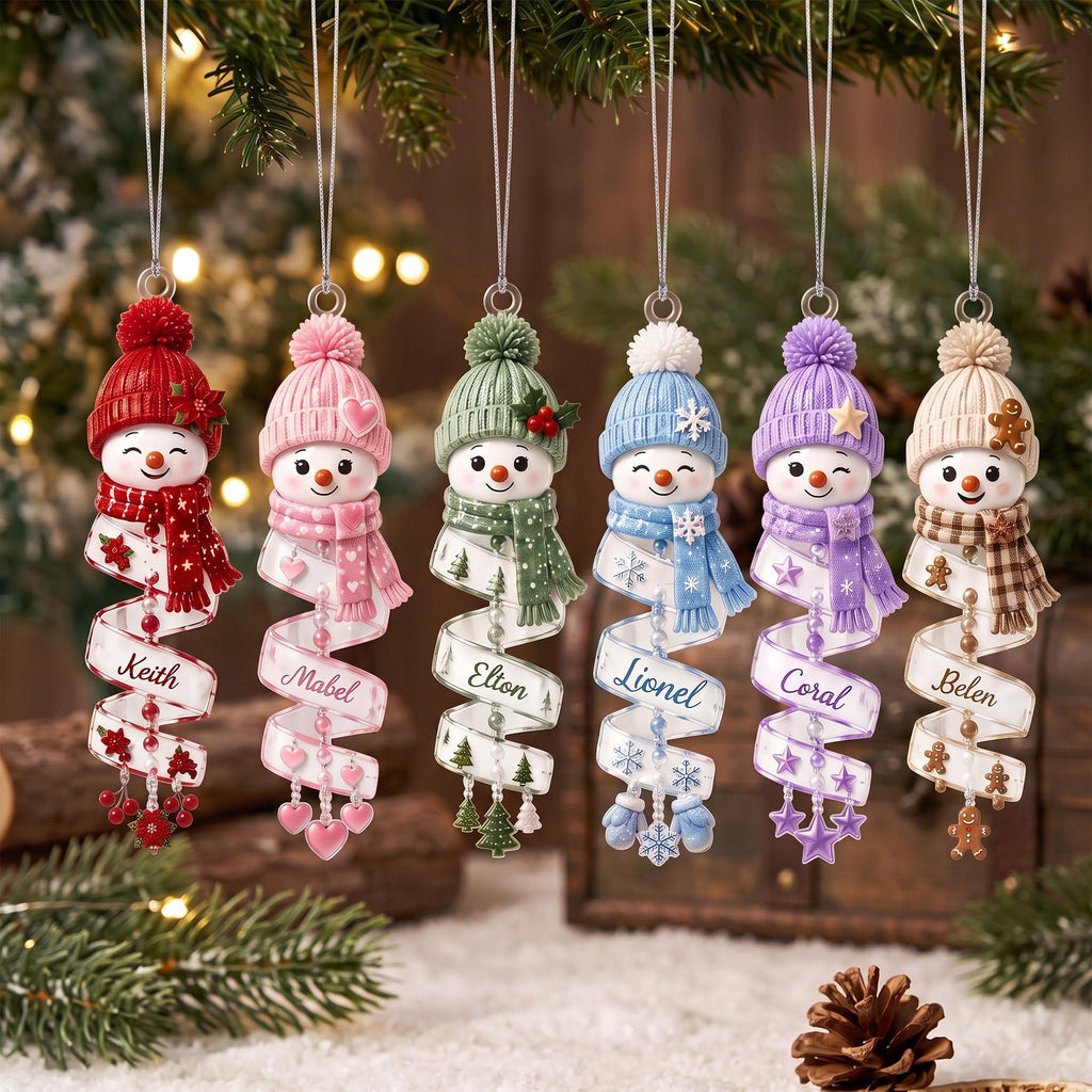 May include: Six hanging snowman ornaments with knit hats and scarves in red, pink, green, blue, purple, and beige. Each snowman features a spiral ribbon base printed with the names Keith, Mabel, Elton, Lionel, Coral, and Belen, accented with small charms.
