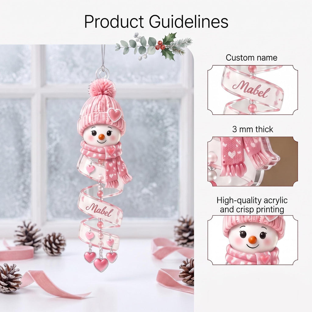 May include: A hanging acrylic snowman ornament featuring a pink knit hat with a pom-pom, a matching pink scarf with white hearts, and a spiral tail. The ornament displays the custom name Mabel, measures 3 mm thick, and includes heart charms.