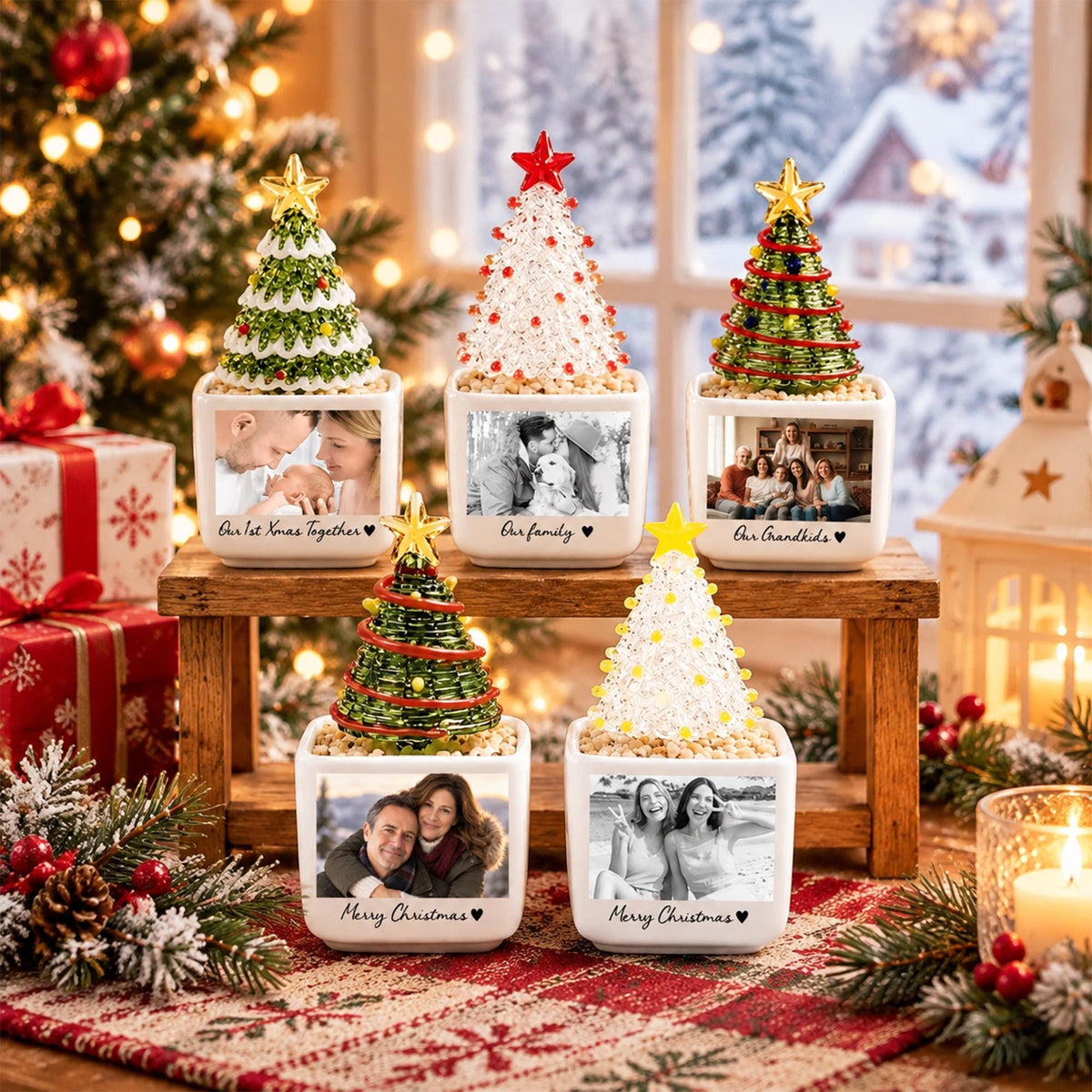 May include: Five square white ceramic planters, each topped with a decorative Christmas tree and a personalized black and white photograph. The trees feature varied designs including green wire, clear beads, and gold stars. Each planter displays custom text.