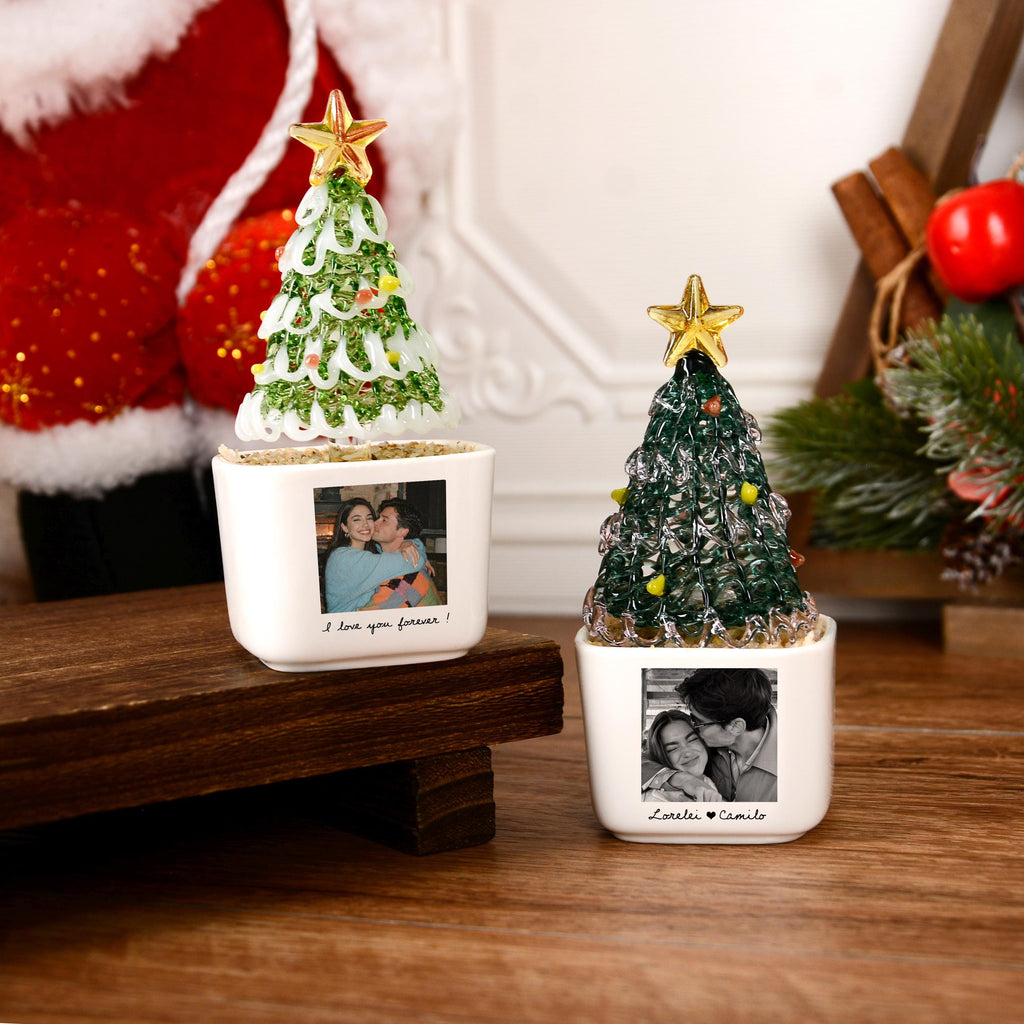 May include: Two white ceramic square planters featuring glass Christmas trees with gold stars on top. Each planter displays a black and white photograph of a couple. The left planter has the text I love you forever! and the right has Lorelei &hearts; Camilo.