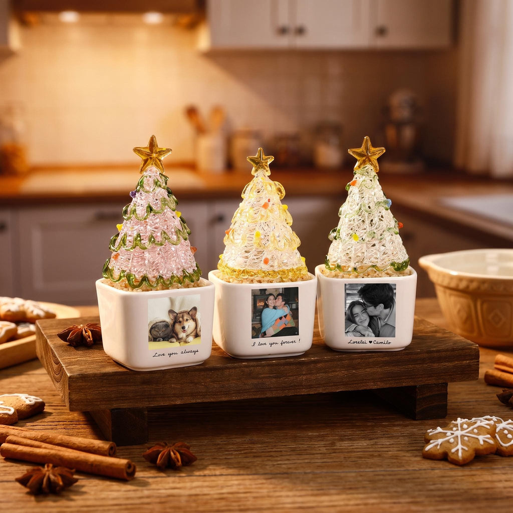 May include: Three decorative glass Christmas trees with gold star toppers, each set in a white square ceramic planter. The planters feature personalized black and white photographs and text, including "Love you always," "I love you forever," and "Lorelei & Camilo."