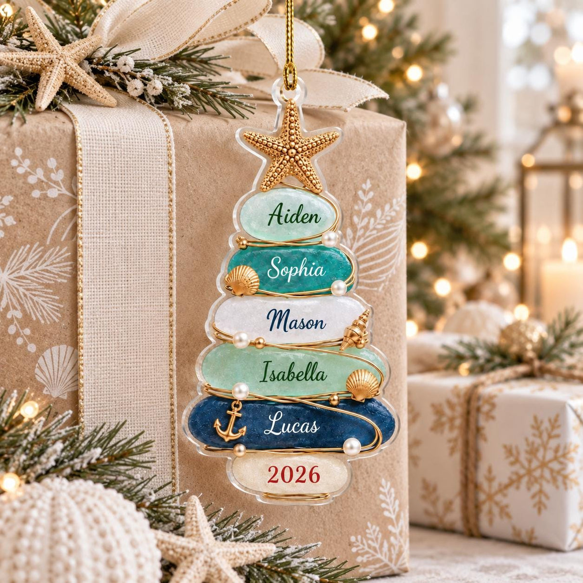 May include: A clear, tree-shaped Christmas ornament featuring five horizontal layers in shades of light green, teal, white, and dark blue. Each layer is inscribed with the names Aiden, Sophia, Mason, Isabella, and Lucas, with 2026 at the base.