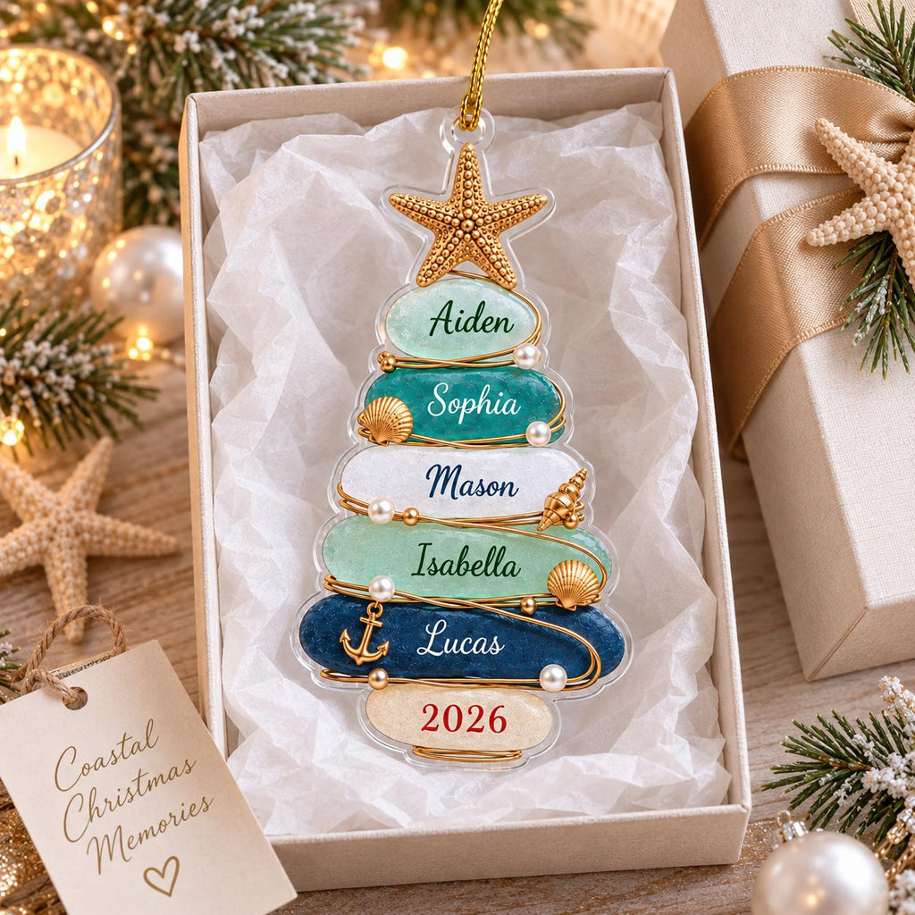 May include: A clear, tree-shaped Christmas ornament featuring stacked, smooth, oval-shaped segments in shades of light green, teal, white, and dark blue. The ornament is decorated with a gold starfish, small seashells, pearls, and an anchor charm.