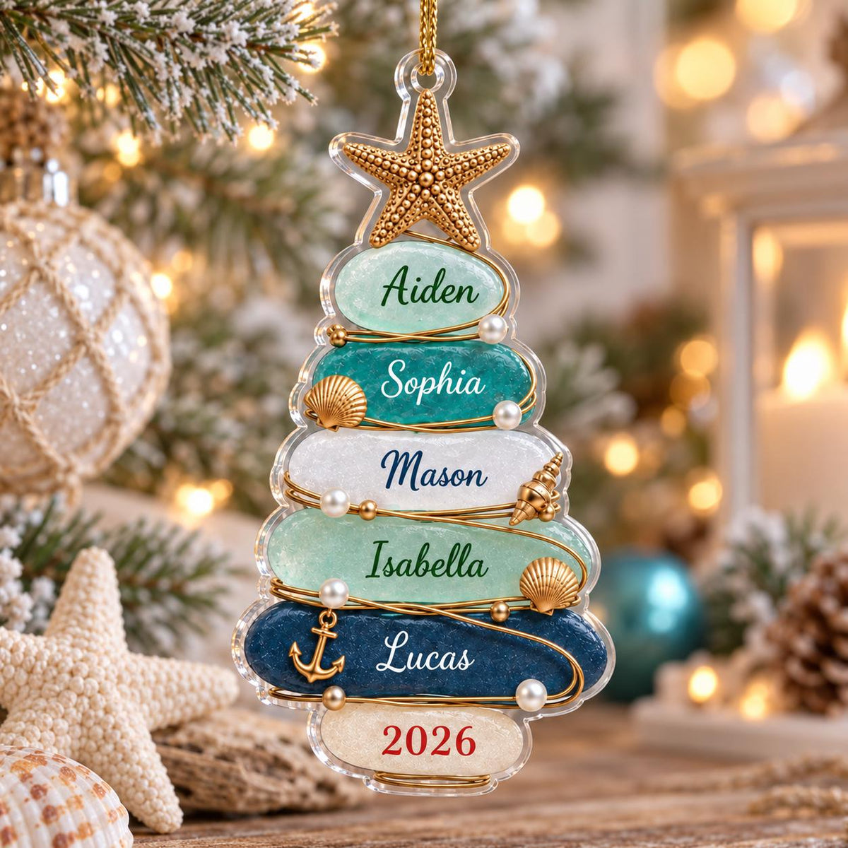 May include: A clear acrylic Christmas tree ornament featuring a gold starfish topper and six horizontal layers in shades of blue, green, and white. Each layer displays a name: Aiden, Sophia, Mason, Isabella, Lucas, and the year 2026 in red.