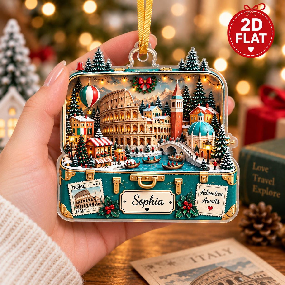 May include: A flat, suitcase-shaped Christmas ornament featuring a detailed 3D-style illustration of Rome with the Colosseum, a canal, and snowy trees. The teal suitcase base displays the name Sophia, a Rome Italy stamp, and the text Adventure Awaits.