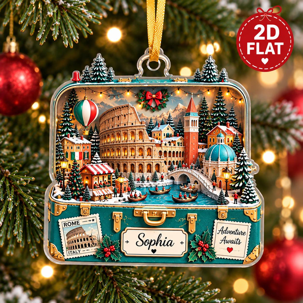 May include: A flat, suitcase-shaped Christmas ornament featuring a detailed scene of Rome, including the Colosseum, a canal, and a hot air balloon. The suitcase is teal with gold accents, labeled with the name Sophia and the text Adventure Awaits.