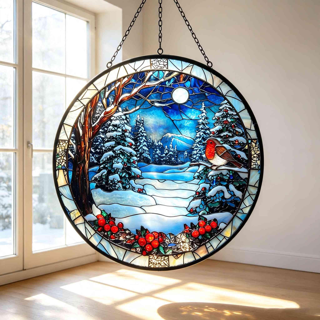 May include: A circular stained glass suncatcher featuring a winter landscape with a robin perched on a snowy branch. The scene includes snow-covered pine trees, a bright moon in a deep blue sky, and a border decorated with vibrant red holly berries.