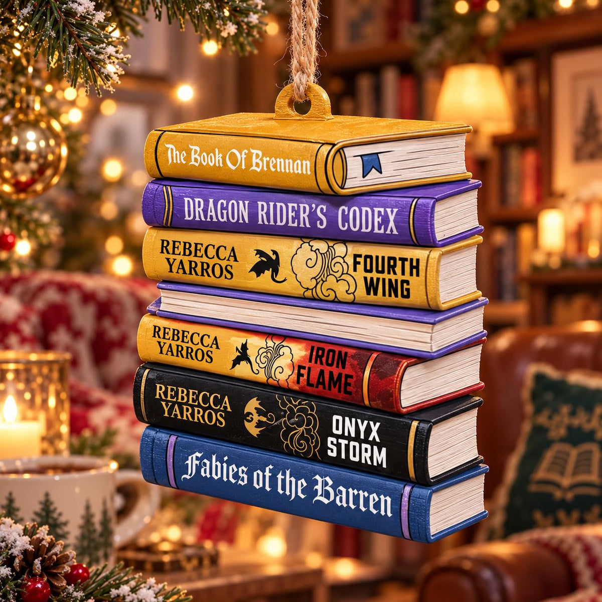 May include: A decorative hanging ornament shaped like a stack of seven books. The spines feature titles including The Book Of Brennan, Dragon Rider's Codex, Fourth Wing, Iron Flame, Onyx Storm, and Fabies of the Barren, with author Rebecca Yarros listed.
