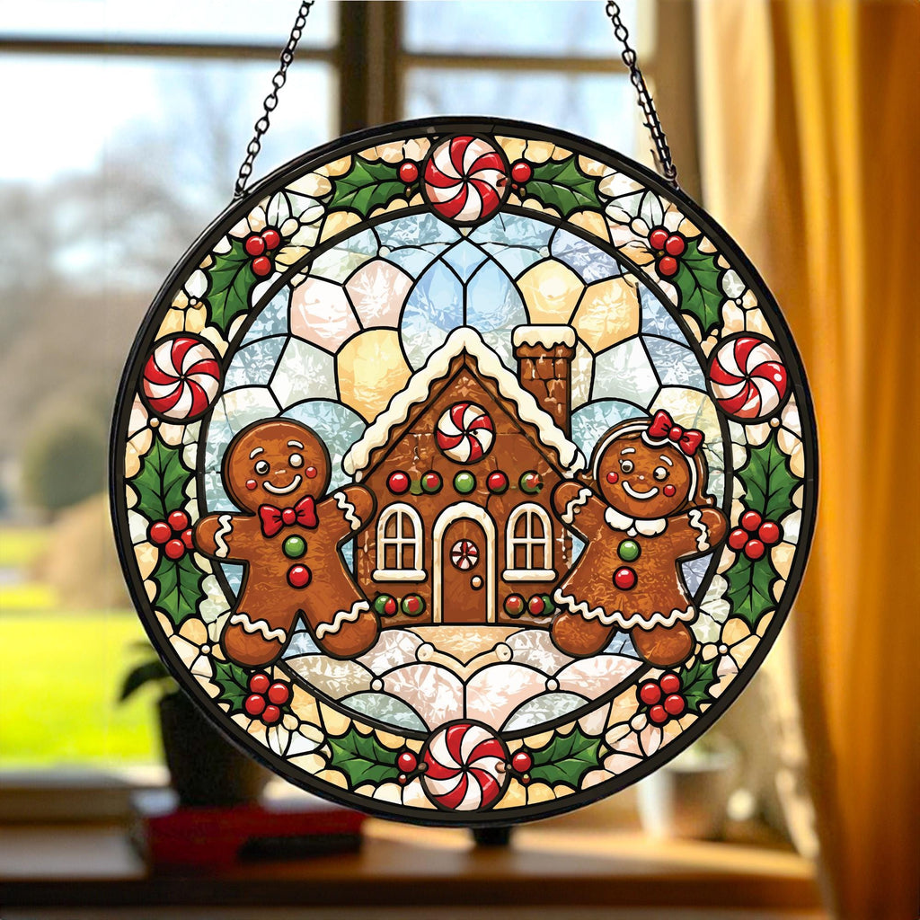 May include: A circular stained glass suncatcher featuring a gingerbread house in the center flanked by two gingerbread figures. The border is decorated with red and white peppermint candies and green holly leaves with red berries.