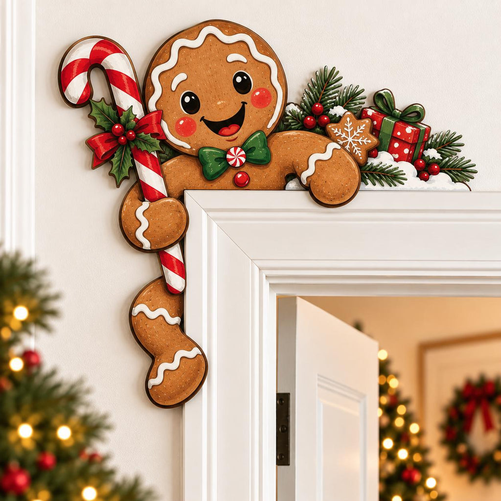 May include: A gingerbread person door corner decoration featuring a smiling face, a green bowtie, and a red and white candy cane. The design includes festive accents like holly leaves, red berries, a small gift box, and pine branches.
