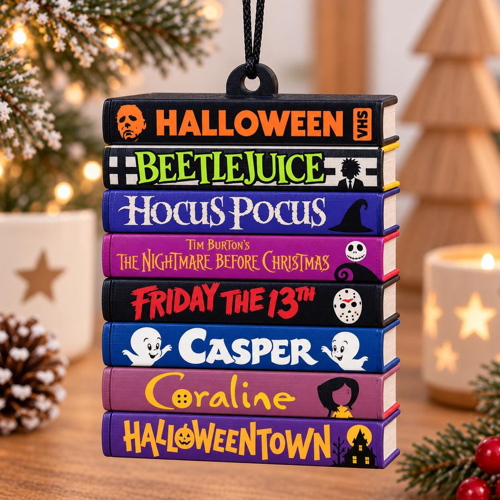 May include: A hanging ornament shaped like a stack of eight colorful books with movie titles including Halloween, Beetlejuice, Hocus Pocus, The Nightmare Before Christmas, Friday the 13th, Casper, Coraline, and Halloweentown, suspended by a black cord.