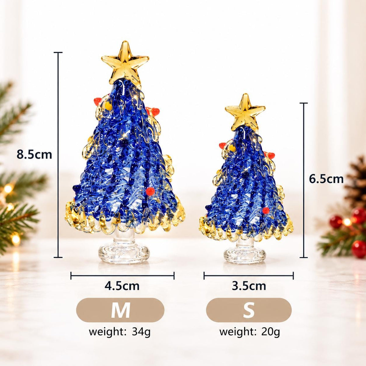 May include: Two blue glass Christmas tree figurines with gold star toppers and small colorful accents. The medium tree is 8.5cm tall and 4.5cm wide, weighing 34g. The small tree is 6.5cm tall and 3.5cm wide, weighing 20g. Both stand on clear glass bases.