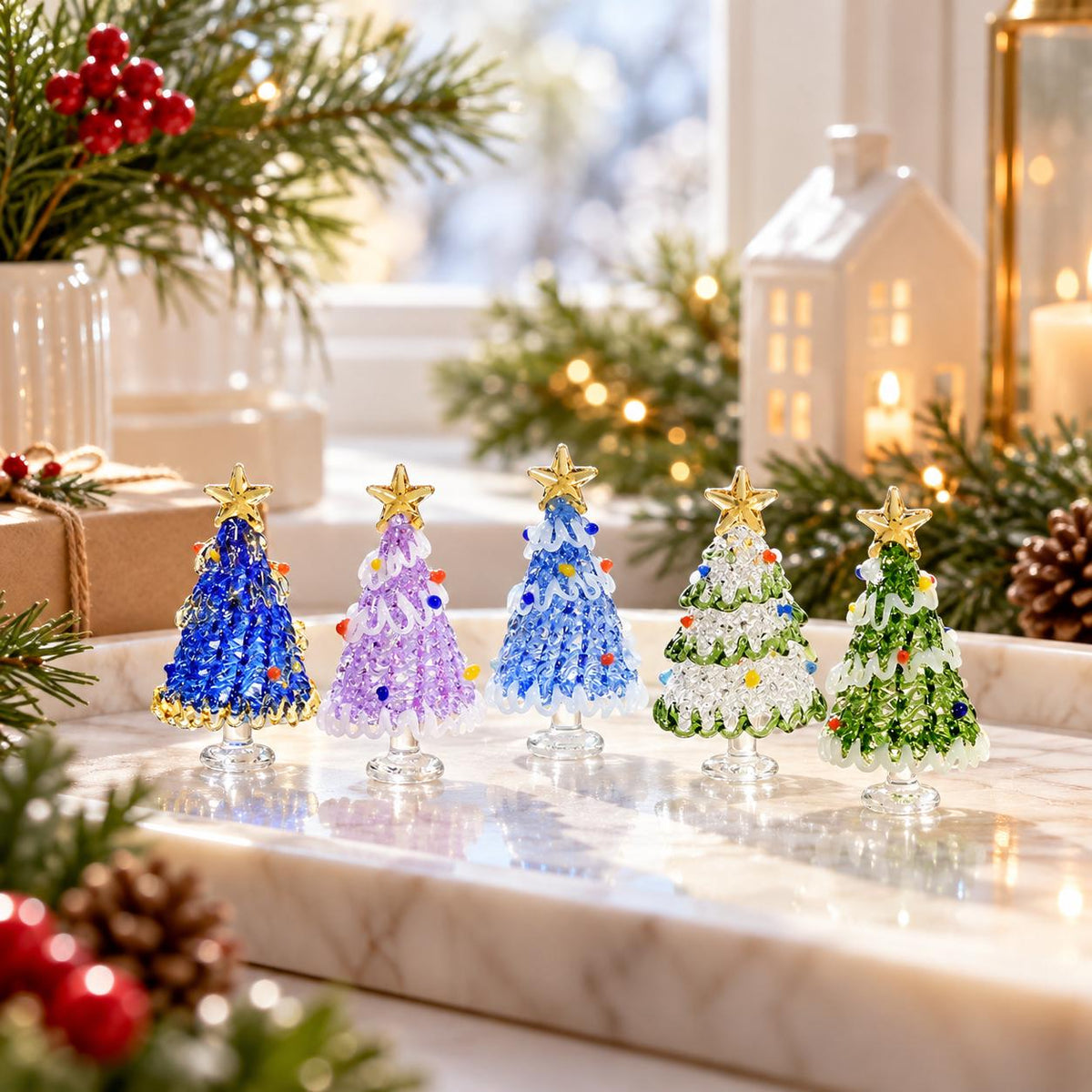 May include: Five miniature glass Christmas trees standing in a row. Each tree features a textured, crystalline body in blue, purple, light blue, clear, or green, topped with a gold star and decorated with small, colorful glass bead ornaments.