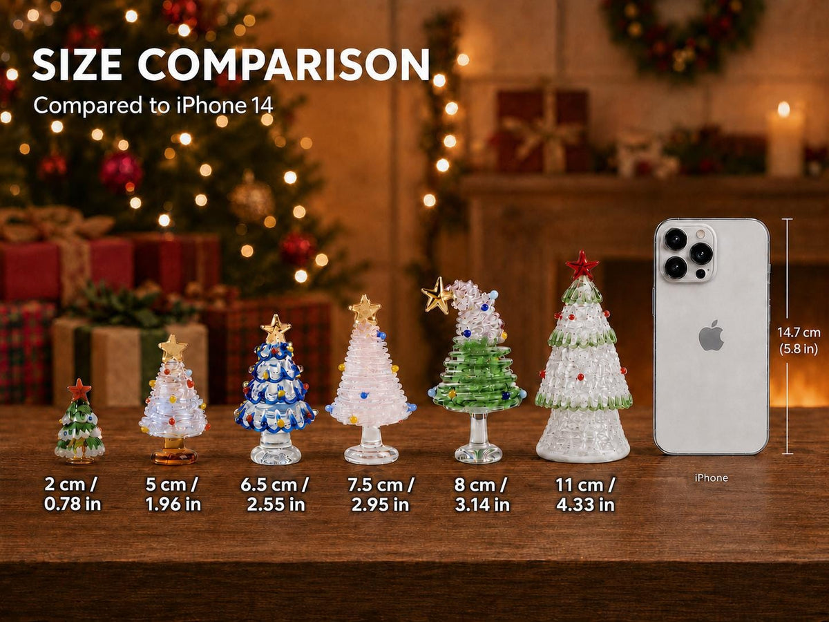 May include: Six glass Christmas tree figurines of varying heights from 2 cm to 11 cm, each topped with a star, displayed next to an iPhone 14 measuring 14.7 cm or 5.8 inches. The trees feature colorful glass beads and textured surfaces.